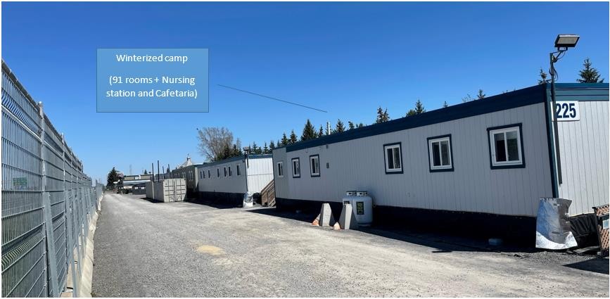 Series of trailers behind a fence and connected by a road. 91 rooms, nursing station and cafeteria.